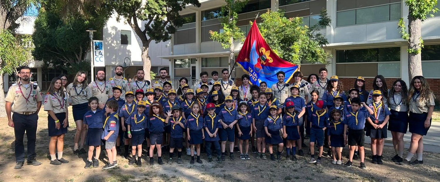 Homenetmen Los Angeles scouting group and leaders outside with their flag